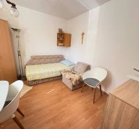Living room in a 4-room apartment with a wooden decor floor and a wardrobe.