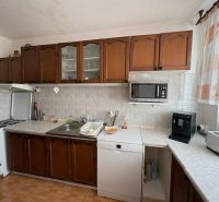 Kitchen in a 4-room apartment with dark cabinets and kitchen appliances.