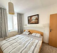 Bedroom with a large bed and a painting in a 4-room apartment.