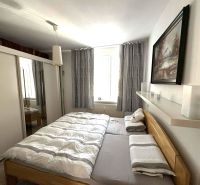 Bedroom in a 4-room apartment with a large bed, wardrobe, and decorative painting.