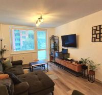 Living room in light tones, floor with wood decor, comfortable sofa, 3-room apartment.