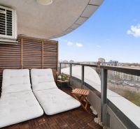 A balcony with comfortable loungers, a view of Bratislava from Bajkalská, ideal for a 3-room apartment.