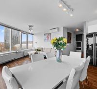 Interior of a 3-room apartment with a dining table and a wooden decor floor.