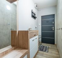 The interior of the hallway with a wooden decor floor in a 2-room apartment.