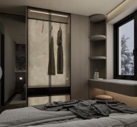A bedroom in a holiday apartment with storage space next to the window.