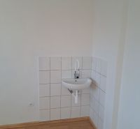 Offices with a sink, white walls, and a floor with a wood decor.