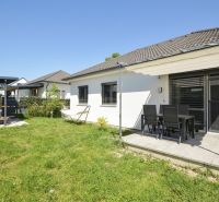 A family house in Rajka with a terrace, garden seating, and a green lawn.
