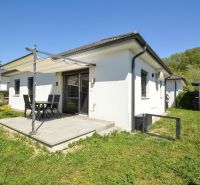 A family house in Rajka with a terrace and a shelter in the middle of a green garden.