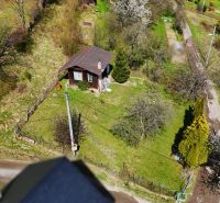 A wooden cottage surrounded by trees and nature in Krásno nad Kysucou.