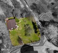 A cottage in Krásno nad Kysucou with a large lawn and surroundings from a bird's eye view.