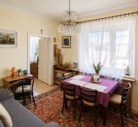 Living room in a family house with a sofa, dining area, and decorations.