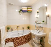 Bathroom in a family house with a bathtub, sink, and storage shelves.