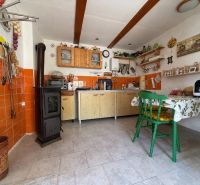 A kitchen in a family house with tiles and orange tiles.