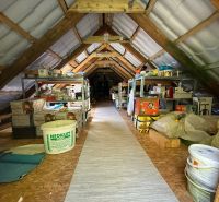 The attic of the family house used as a storage space with a wooden floor decor.
