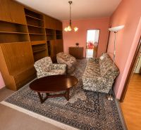 Living room in a 3-room apartment with a sofa, armchairs, and a table on a carpet.