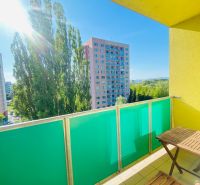The balcony of a 2-room apartment with a view of panel buildings and trees in Košice, Nad jazerom district.