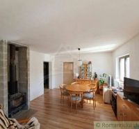 Living room in a family house with a fireplace and a wooden decor floor.
