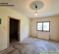 A room in a family house with a bare floor, a window, and lighting.
