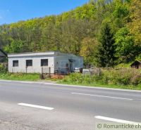 A family house in Šiatorská Bukovinka by the road, surrounded by greenery and forest.