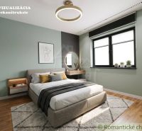 Bedroom in a family house with wood-patterned flooring, light green walls, bed, window.