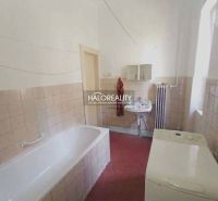 Bathroom in a 2-room apartment with a bathtub, sink, and washing machine.