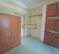 Interior of a 2-room apartment with wooden cabinets and a floor with a wood decor.