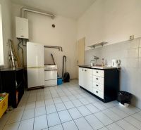 Offices with a kitchenette, tiled floor, stove, refrigerator, and boiler.