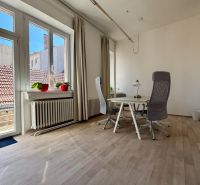 Bright office with wood-patterned flooring and a desk by the window, Hlavná, Trnava.