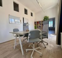 Offices with wood-patterned flooring, white walls, and seating.