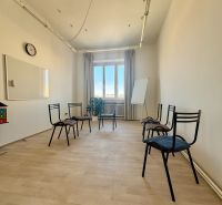 Office with wood-patterned flooring, six chairs, a board, and a window.
