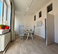 Offices with wood-patterned flooring, chairs, and a desk, view from the window.