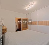 Bedroom with a large built-in wardrobe and bright lighting in a 2-room apartment.