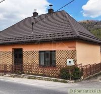 A family house in Reľov with a brown roof and an interesting facade by the road.