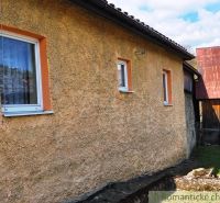 A family house in Reľov with simple plaster and two windows.