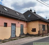 A family house in Reľov with a dark roof and attic windows.