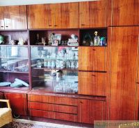 Furniture with glass display cabinets and wood decor in a family house, displaying dishes.