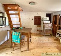 The interior of a cabin with a wooden staircase and a floor with a wooden decor.