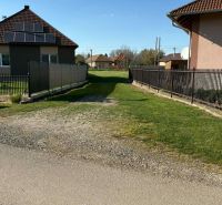 A garden with a lawn between houses in Pozba, suitable for residential plots.