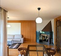 A living room in a 4-room apartment with a fireplace and a wooden decor floor.