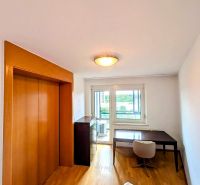 A room with a table, chair, wardrobe, and a floor with wooden decor in a 4-room apartment.