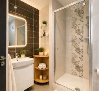 Bathroom in a 3-room apartment with ceramic tiles, a shower, and a mirror with lighting.