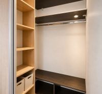 Storage space in a 3-room apartment with shelves and a floor with a wood decor.