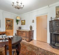 Living room with antique furniture and wood-patterned flooring in a 4-room apartment.
