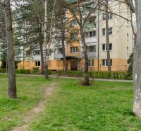 An apartment building on Štúrova Street in Poprad surrounded by trees and a green lawn.