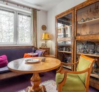 A living room with antique furniture and a wooden decor floor in a 4-room apartment.