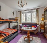A room in a 4-room apartment with a bunk bed and wooden furniture.
