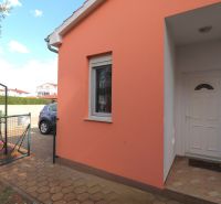 A family house in Vodice with an orange facade and white entrance doors.
