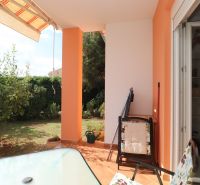 The terrace of a family house in Vodice with seating and a view of the garden.