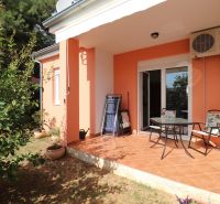 A family house in Vodice with a terrace, garden, and orange facade.