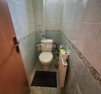 A bathroom with tiles and a radiator in a 3-room apartment.